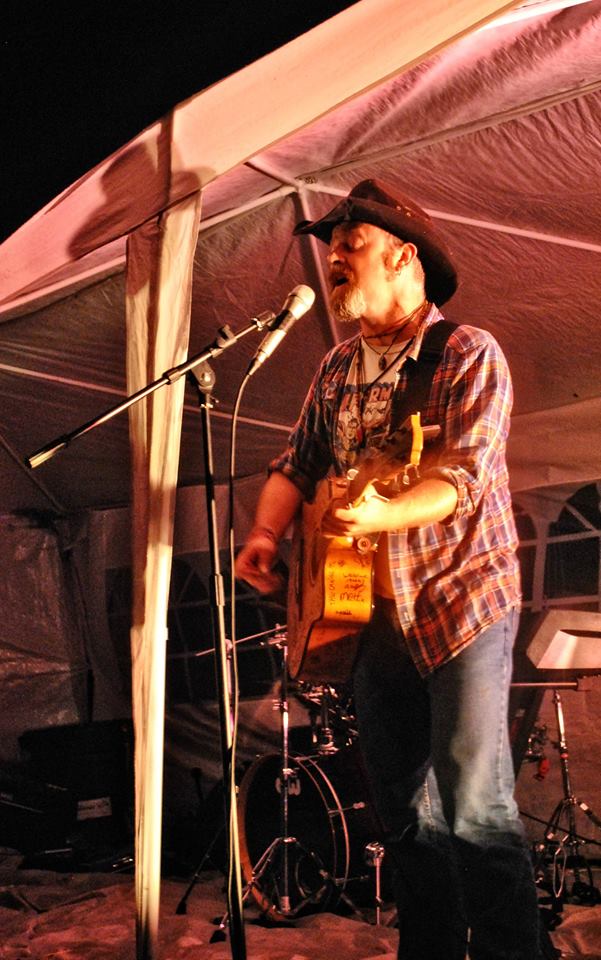 "And the rain beat down and the fire did crackle, and the brewing men did fine business..." Going through strings on The Torch Guitar as though they were paper. Solo onstage at Farmfest, 16/08/2014. Pic by Gav Wyatt.